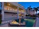 Backyard with a luxurious pool, a water feature, and a two-story house with balconies overlooking the pool at 2829 Seabreeze S Dr, Gulfport, FL 33707