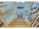 Elegant curved staircase showcases natural wood steps and white railing, adding charm and architectural interest at 2829 Seabreeze S Dr, Gulfport, FL 33707