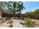Backyard area with trees, plants, pavers, stone, mulch, and a wood fence at 3056 Pepperwood W Ln, Clearwater, FL 33761