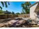 Wide backyard view with trees, plants, stone features, and a tall wood fence at 3056 Pepperwood W Ln, Clearwater, FL 33761