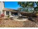Large backyard has a fire pit, trees and a patio outside a screened porch at 3056 Pepperwood W Ln, Clearwater, FL 33761