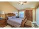Cozy bedroom featuring wooden furniture, a ceiling fan, and a bright window at 3056 Pepperwood W Ln, Clearwater, FL 33761