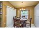 Breakfast nook with a round table, set for four, adjacent to a large window at 3056 Pepperwood W Ln, Clearwater, FL 33761