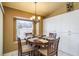 Breakfast nook with a chandelier, a round table set, and ample natural light at 3056 Pepperwood W Ln, Clearwater, FL 33761