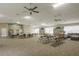 Spacious community room featuring tables, chairs, a bookshelf, and comfortable seating for various activities at 3056 Pepperwood W Ln, Clearwater, FL 33761