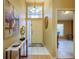 Bright foyer features tile flooring, a stylish console table, and an open doorway, enhancing the welcoming ambiance at 3056 Pepperwood W Ln, Clearwater, FL 33761
