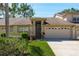 Charming home featuring a 2-car garage, neutral paint, and mature landscaping in a desirable neighborhood at 3056 Pepperwood W Ln, Clearwater, FL 33761