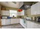 Functional kitchen with white cabinetry and modern appliances, ideal for meal preparation at 3056 Pepperwood W Ln, Clearwater, FL 33761