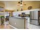 Modern kitchen with white cabinets, stainless steel appliances, and an adjacent dining area, ideal for Gathering meals at 3056 Pepperwood W Ln, Clearwater, FL 33761