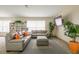 Cozy living room with plush sofas, a bookshelf, and a large TV, perfect for relaxation and entertainment at 3056 Pepperwood W Ln, Clearwater, FL 33761