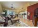 Spacious living room with hardwood floors, a comfortable leather sofa, and a view of the adjacent kitchen and dining area at 3056 Pepperwood W Ln, Clearwater, FL 33761