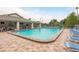 Community pool with lounge chairs, a covered pavilion, and tennis courts, perfect for outdoor recreation at 3056 Pepperwood W Ln, Clearwater, FL 33761