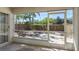 View of screened patio looking onto a stone area with palm trees and a wood fence at 3056 Pepperwood W Ln, Clearwater, FL 33761