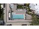 Aerial view of a rooftop pool with stylish lounge chairs and greenery, creating a private oasis at 3435 Bayshore Blvd # 1401S, Tampa, FL 33629