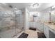 Luxurious bathroom with a glass-enclosed shower and dual vanities with marble countertops at 3435 Bayshore Blvd # 1401S, Tampa, FL 33629