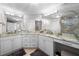 Bright bathroom featuring dual sinks with marble countertops and a decorative lighting fixture at 3435 Bayshore Blvd # 1401S, Tampa, FL 33629