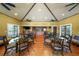 Spacious common room with a vaulted ceiling and dark wood flooring, featuring multiple dining tables and a kitchenette at 3435 Bayshore Blvd # 1401S, Tampa, FL 33629