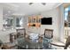 Bright dining area with glass table, built-in cabinets and a view to the kitchen and balcony at 3435 Bayshore Blvd # 1401S, Tampa, FL 33629