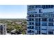 Exterior view of a condo with balconies and a stunning view of the trees and city at 3435 Bayshore Blvd # 1401S, Tampa, FL 33629