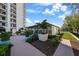 Exterior view featuring manicured landscaping and a building with a wooden walkway under a bright sky at 3435 Bayshore Blvd # 1401S, Tampa, FL 33629