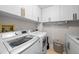 Bright laundry room featuring white appliances, cabinets with decorative pulls, and ample storage space at 3435 Bayshore Blvd # 1401S, Tampa, FL 33629