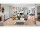 Bright living room featuring a piano, two chairs, fireplace, and beautiful bay windows showcasing a serene outdoor view at 3435 Bayshore Blvd # 1401S, Tampa, FL 33629