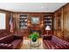 Inviting living room featuring a fireplace, bookshelves, and comfortable leather seating at 3435 Bayshore Blvd # 1401S, Tampa, FL 33629