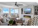 Bright living room featuring floor to ceiling windows offering water views, stylish furnishings, and an inviting fireplace at 3435 Bayshore Blvd # 1401S, Tampa, FL 33629