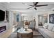 Bright living room with fireplace, plush seating, and access to balcony at 3435 Bayshore Blvd # 1401S, Tampa, FL 33629