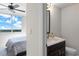 Cozy powder room with modern vanity and a partial view of a bedroom with nice blue skies at 3435 Bayshore Blvd # 1401S, Tampa, FL 33629