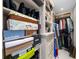 Well-organized walk-in closet with storage boxes and hanging clothes in an organized manner at 3435 Bayshore Blvd # 1401S, Tampa, FL 33629