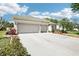 Charming single-Gathering home showcasing an attached three-car garage and a well-maintained lawn and garden at 3503 Williston Loop, Land O Lakes, FL 34639