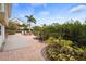 A spacious backyard patio with seating surrounded by lush landscaping offers a tranquil retreat at 378 Tennessee Ave, Crystal Beach, FL 34681