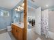 Bathroom with a vanity, decorative mirror, tile flooring and a view of a shower and living area at 378 Tennessee Ave, Crystal Beach, FL 34681