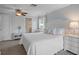 Bright bedroom featuring a king bed, ceiling fan, bedside tables and ensuite bathroom at 378 Tennessee Ave, Crystal Beach, FL 34681