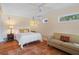 Comfortable bedroom featuring warm-toned walls, a queen-sized bed, and a cozy seating area at 378 Tennessee Ave, Crystal Beach, FL 34681