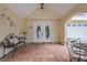 Welcoming front porch with double doors, tiled flooring, and wrought-iron furniture creates a cozy entry at 378 Tennessee Ave, Crystal Beach, FL 34681