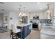 Modern kitchen with an island, stainless steel appliances, tile backsplash, and light-colored cabinets providing ample storage at 378 Tennessee Ave, Crystal Beach, FL 34681