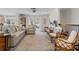 Inviting living room with comfortable seating, tiled floors, and a sliding glass door providing access to the outdoor space at 378 Tennessee Ave, Crystal Beach, FL 34681