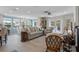 Cozy living room with neutral furniture, large windows, and elegant decor, with the kitchen and dining area visible at 378 Tennessee Ave, Crystal Beach, FL 34681