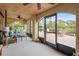 Relaxing screened-in patio with comfortable seating and views of the lush backyard at 378 Tennessee Ave, Crystal Beach, FL 34681