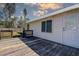 Home exterior showcasing a wooden deck, white siding, and neatly manicured lawn at 3801 40Th N Ave, St Petersburg, FL 33714