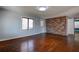 Cozy living room showing hardwood floors, a brick wall, and natural light at 3801 40Th N Ave, St Petersburg, FL 33714