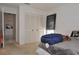 Bedroom with carpet, featuring closet with doors, and an open doorway into another room at 3876 Darston St, Palm Harbor, FL 34685