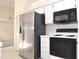 Efficient kitchen area with white cabinets, laminate countertops, stainless steel appliances, and durable tile flooring at 3876 Darston St, Palm Harbor, FL 34685