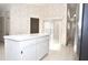 Bright kitchen featuring white cabinets, an island, stainless steel appliances, and easy-to-clean tile floors at 3876 Darston St, Palm Harbor, FL 34685