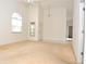 Inviting living room featuring an arched window, neutral carpet, high ceilings and an adjacent room at 3876 Darston St, Palm Harbor, FL 34685