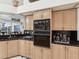 Cozy kitchen features wooden cabinets, a black tiled backsplash, and modern appliances at 3909 Tarian Ct, Palm Harbor, FL 34684