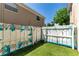 Backyard features a unique, painted fence and artificial grass, offering a private and decorative outdoor space at 408 S Arrawana Ave # B4, Tampa, FL 33609