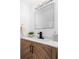 Modern bathroom features a stylish vanity with a wooden cabinet, marble countertop, and matte black fixtures at 408 S Arrawana Ave # B4, Tampa, FL 33609